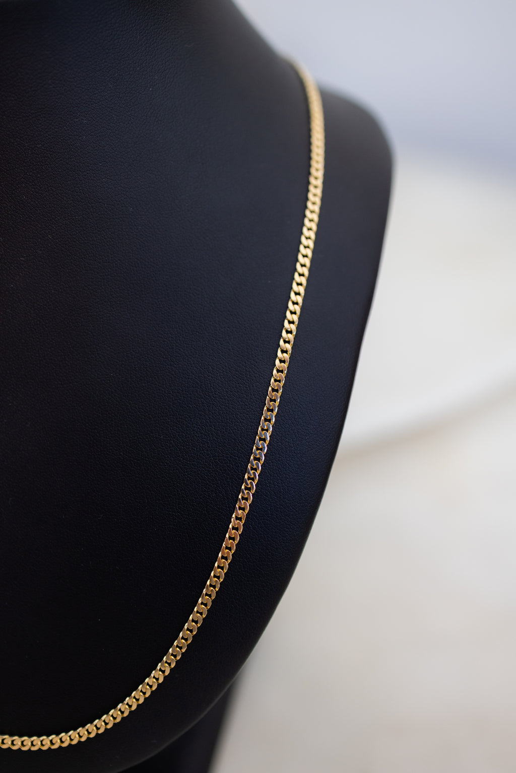 Three-quarter angled view of the 3.05mm 18ct yellow gold Cuban link chain