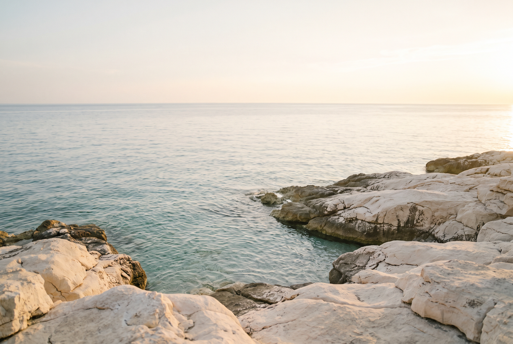 Pale limestone meeting the calm Adriatic
