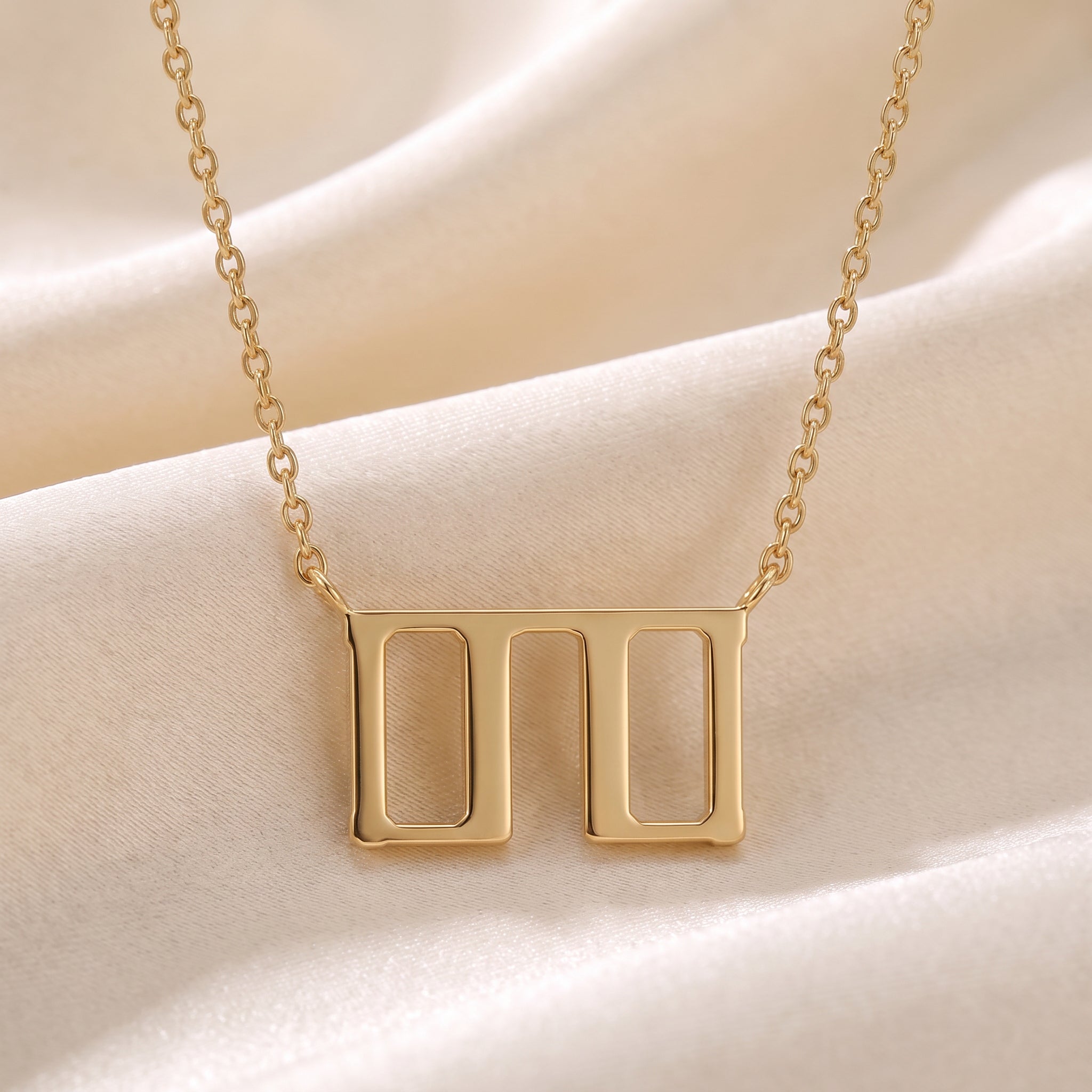 Glagolitic letter T (Tvrdo) pendant necklace in 9ct yellow gold on silk