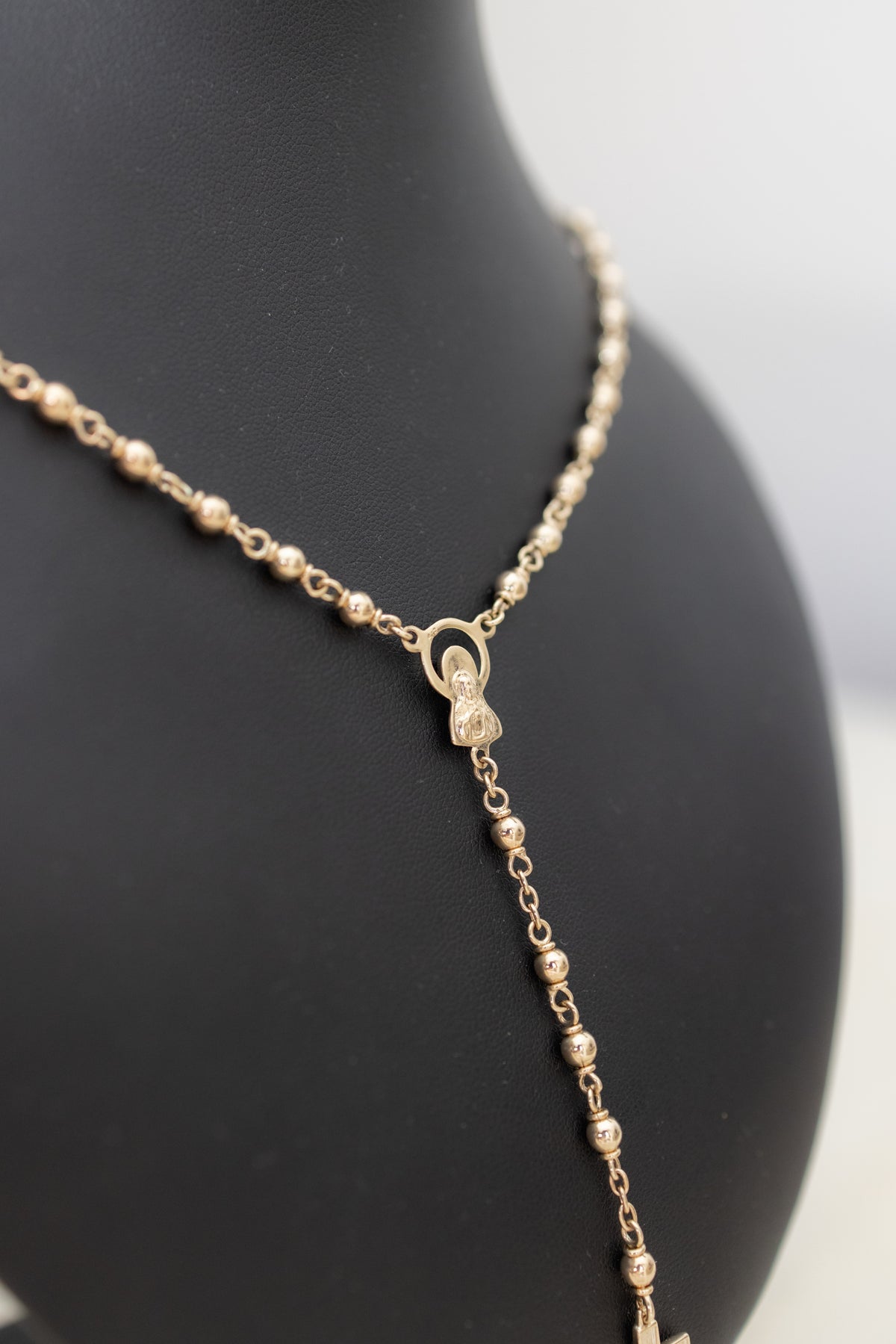 Close-up of the Marian centrepiece on the handmade 9ct gold rosary necklace