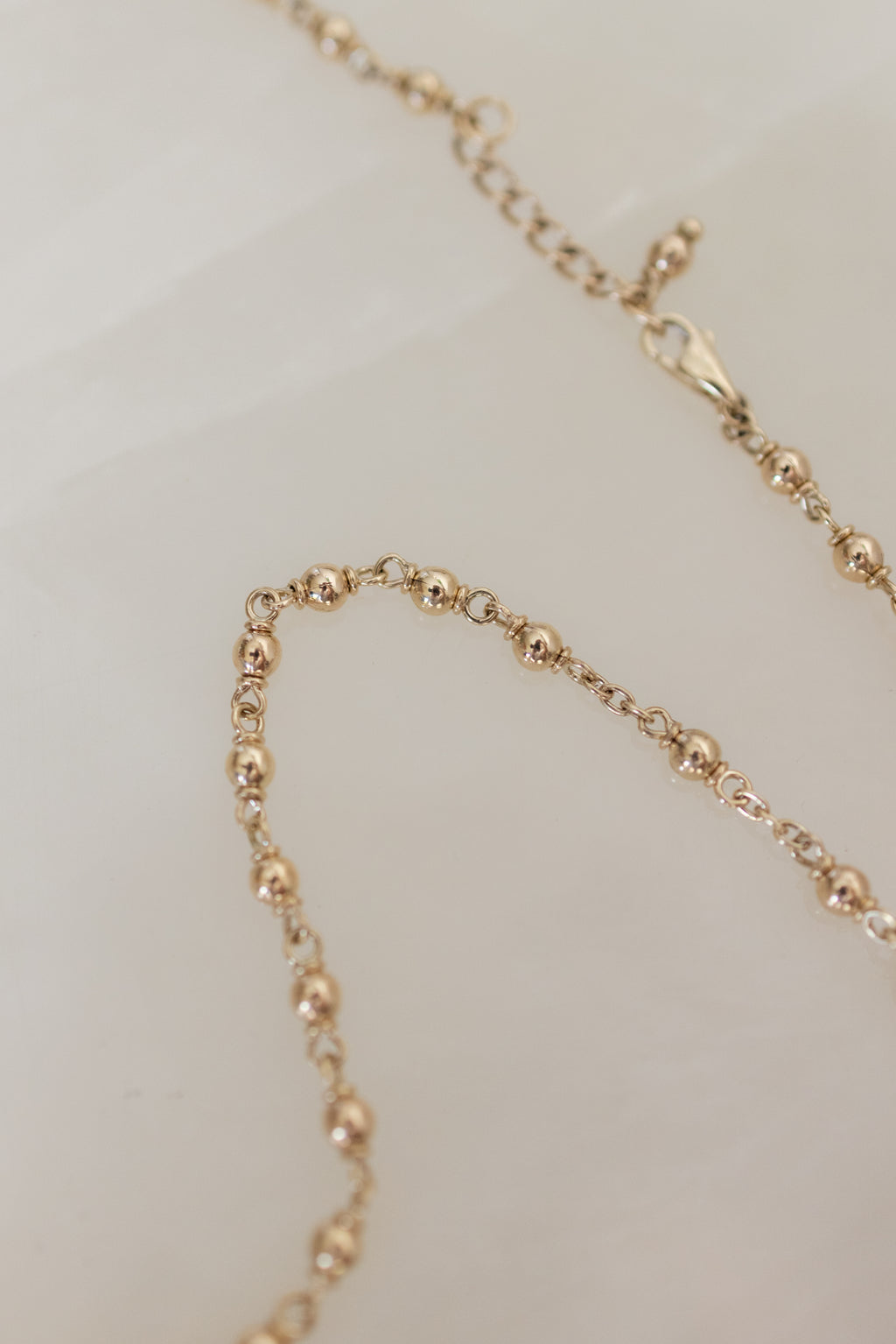 Flat lay of the lobster clasp and the adjustable 58cm to 61cm extension chain