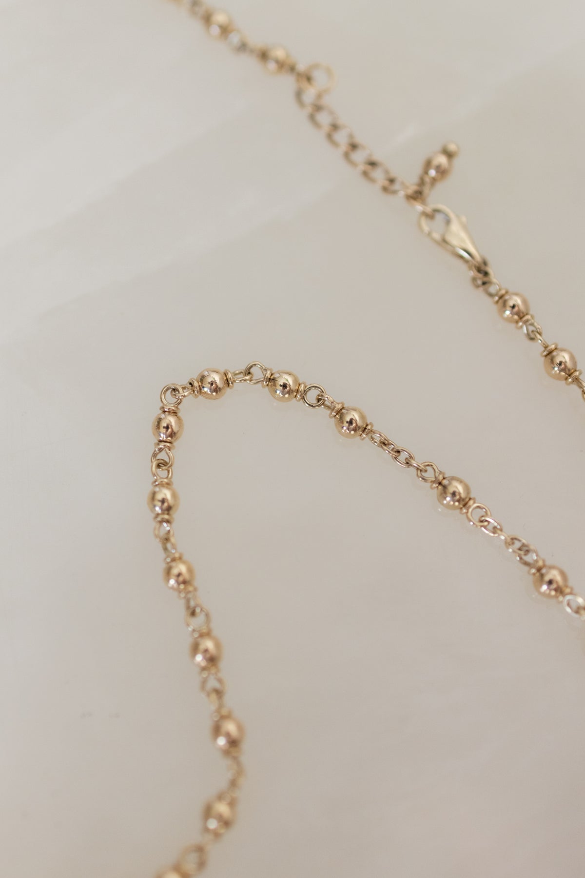Flat lay of the lobster clasp and the adjustable 58cm to 61cm extension chain