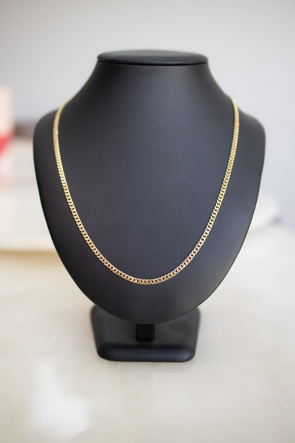 Solid 9ct yellow gold 3.3mm handmade Cuban link chain shown full length on a bust