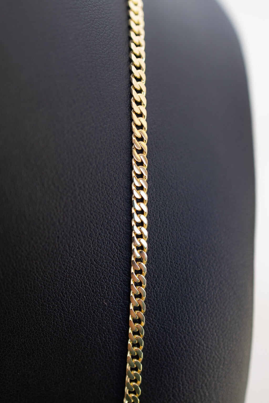 Macro detail of the diamond-cut Cuban links on the 3.3mm handmade 9ct gold chain