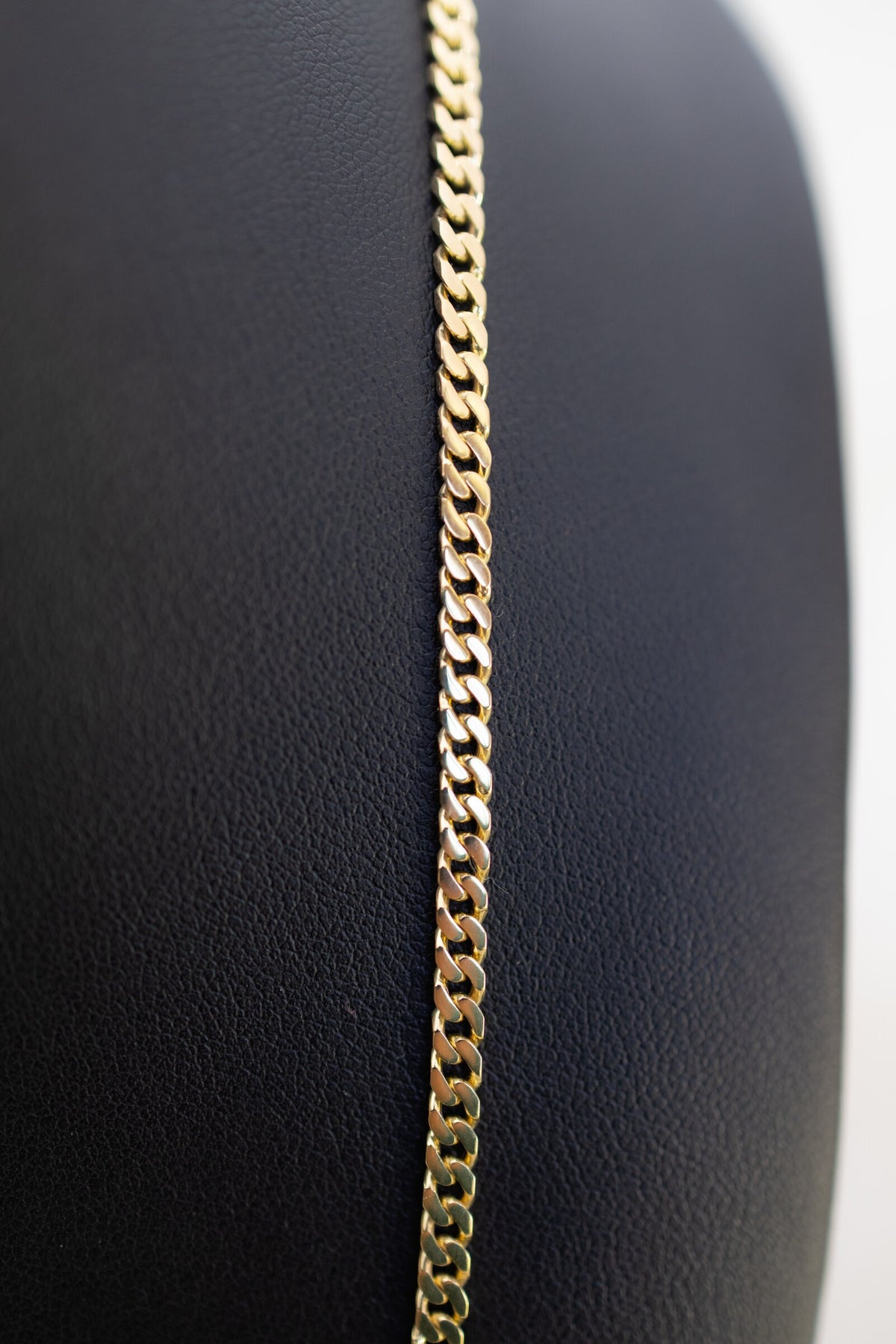 Macro detail of the diamond-cut Cuban links on the 3.3mm handmade 9ct gold chain