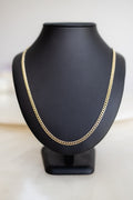 Handmade 4.1mm Cuban link chain in 9ct yellow gold on a display bust, front view