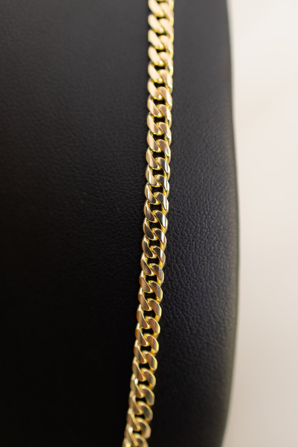 Macro detail of the heavy polished Cuban links on the 4.4mm handmade 9ct gold chain
