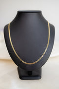 Italian made 3mm Cuban link chain in 9ct yellow gold on a display bust, front view